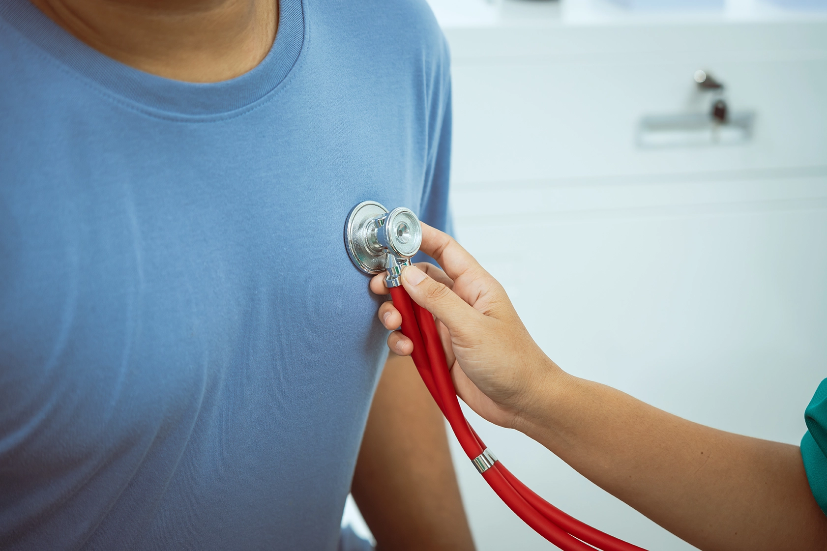 A cardiologist measures a patient’s heart rate