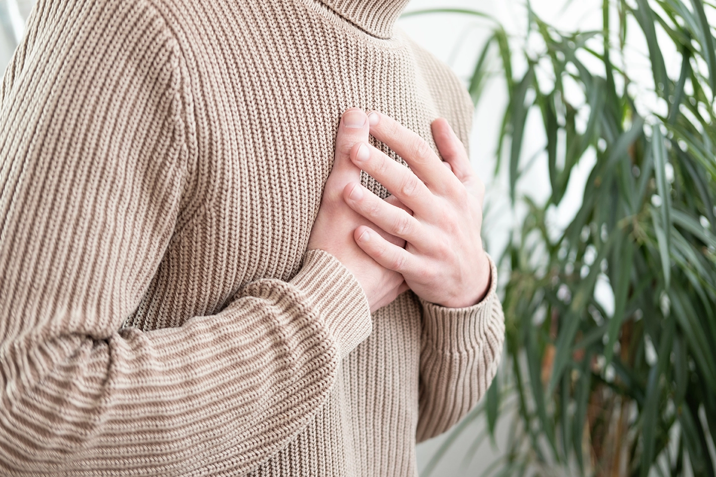 A man experiencing uncomfortable heart symptoms