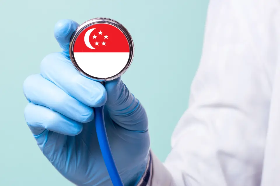 Cardiologist holding a stethoscope featuring the Singapore flag